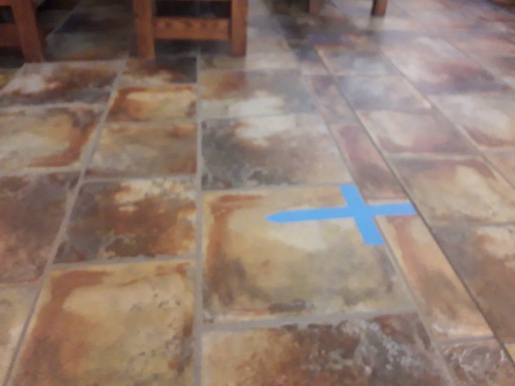 Cross sign marks stuck on the floor of the middle aisle.
St. Thomas Aquinas Catholic Church, Avondale , Az,USA.Photo by Jorge Mission