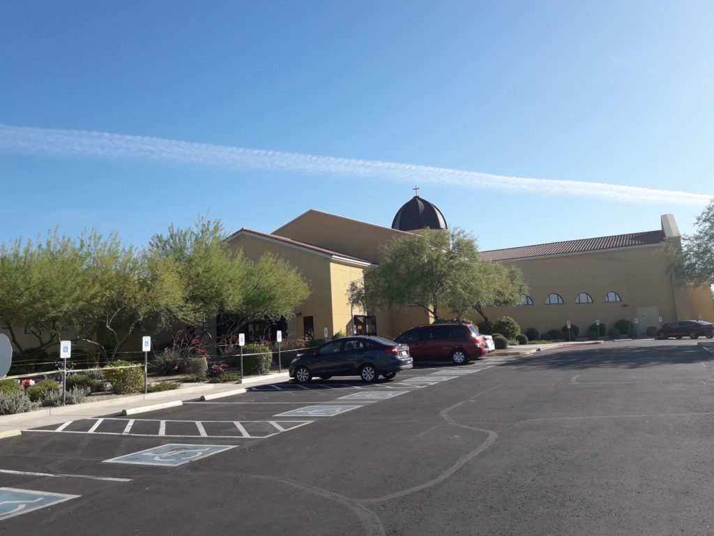 Parking spaces near St. Claire of Assisi with a couple of cars. St. Claire of Assisi, Surprise, Arizona, USA. Photo by Jorge Mission